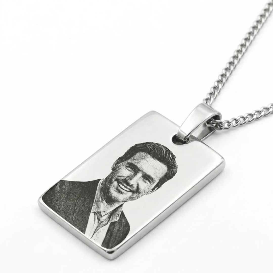 Silver necklace with a rectangular pendant engraved with a portrait on a white background