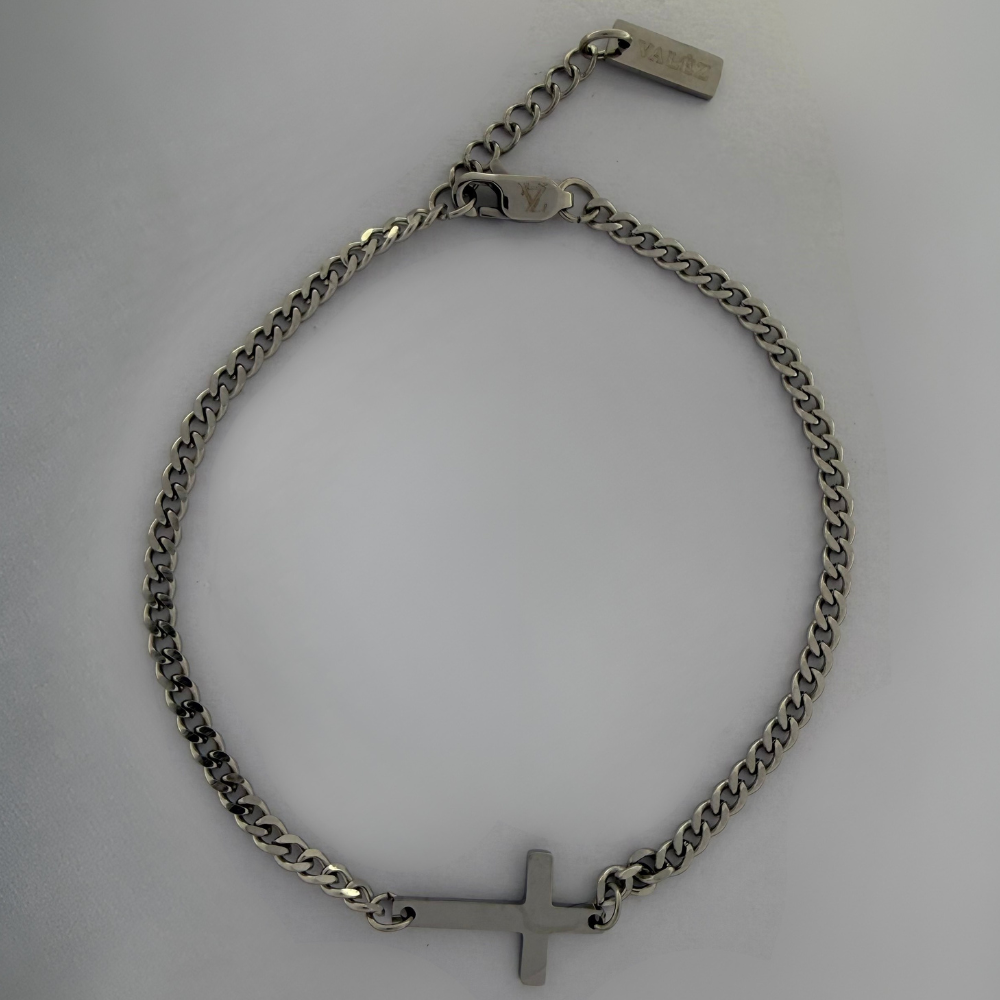 Stainless steel bracelet with a cross on a light gray background