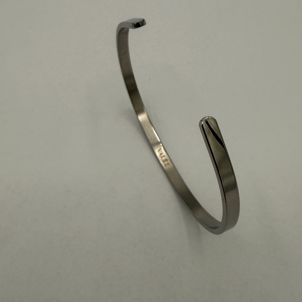 Stainless steel bracelet on a light gray background
