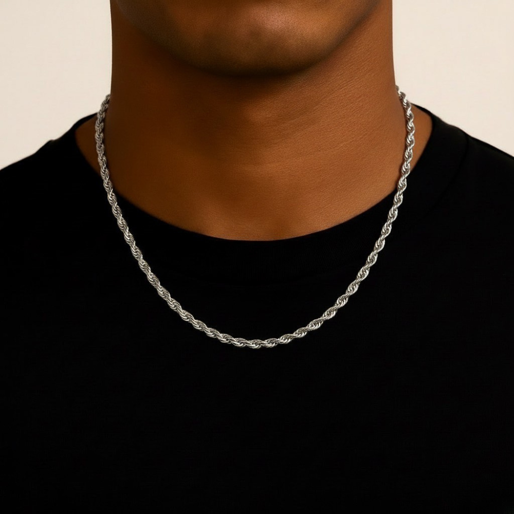 Stainless steel rope chain necklace on a person wearing a black shirt against a beige background