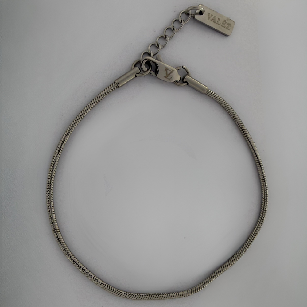 Stainless steel square bracelet with a visible brand logo on a gray background