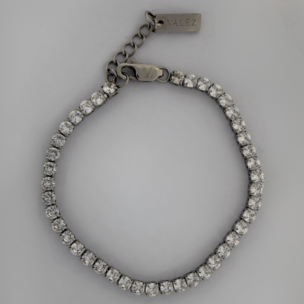 Stainless steel bracelet with stones on a gray background