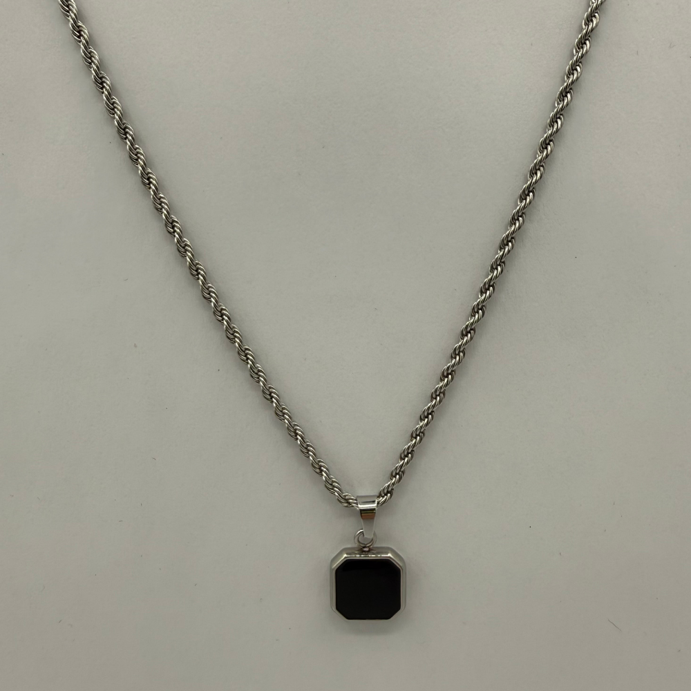 Necklace with a square pendant on a light gray background