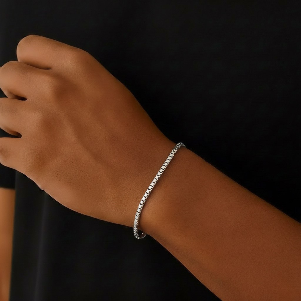 Stainless steel bracelet on a wrist against a black background