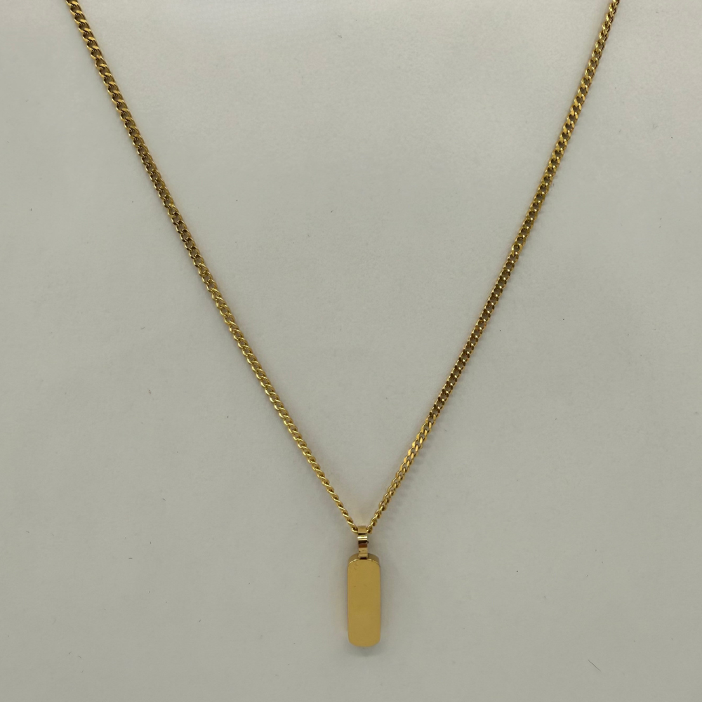 Gold necklace with a pendant on a light gray background
