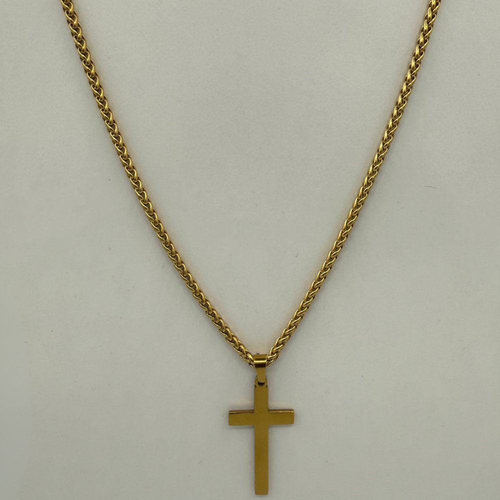 Gold cross necklace on a light gray background