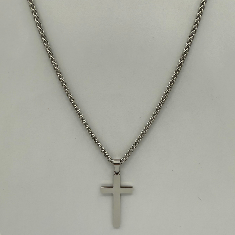 Stainless steel cross necklace on a light gray background