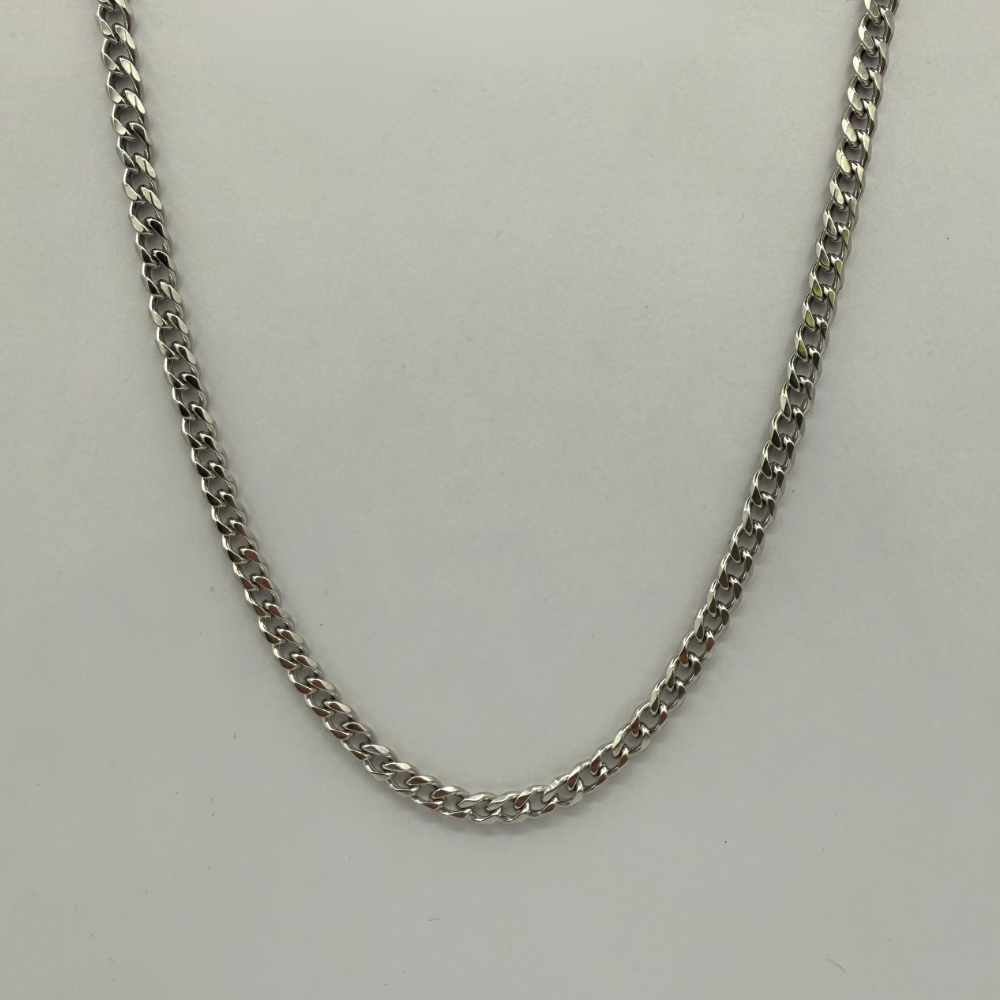 stainless steel cuban chain necklace on a light gray background