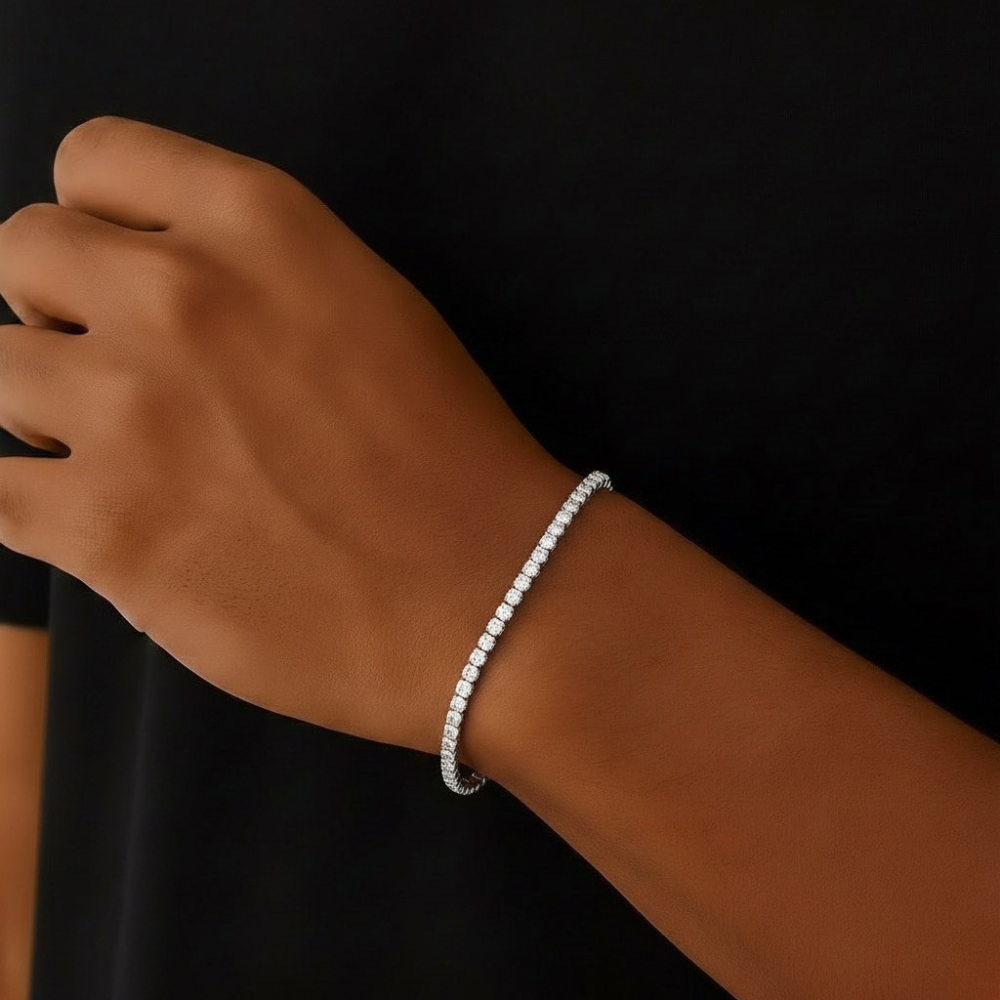 Stainless steel bracelet on a wrist against a black background